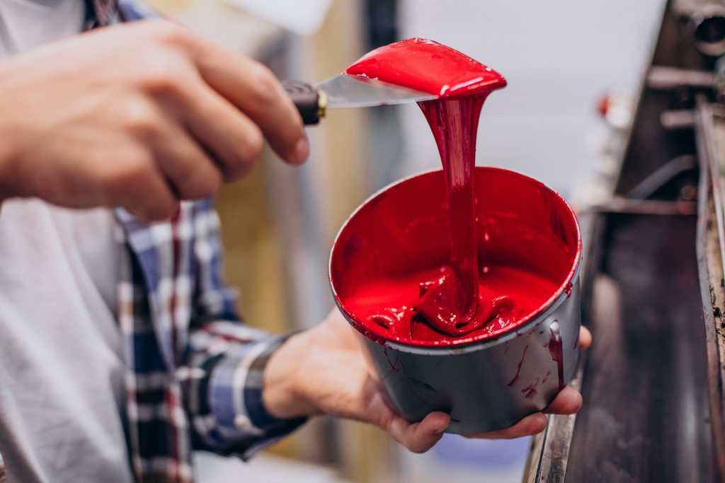 man-working-printing-house-with-paper-paints (1)-min