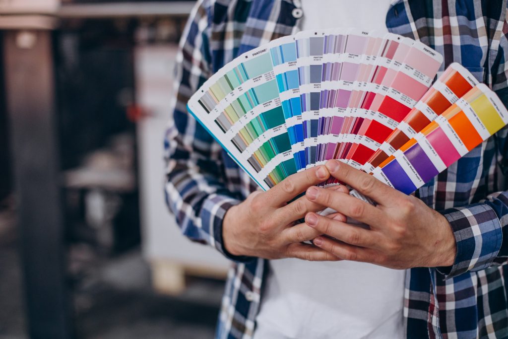 man-working-printing-house-with-paper-paints (2)-min